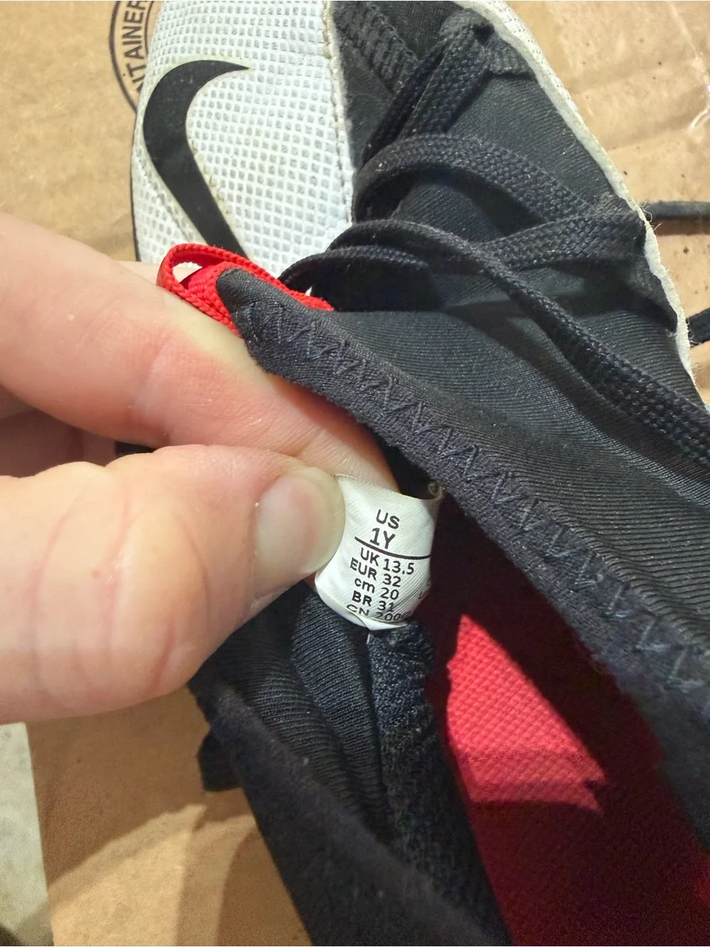 Nike Youth White and Black Athletic Trainers with Red Pull Tabs